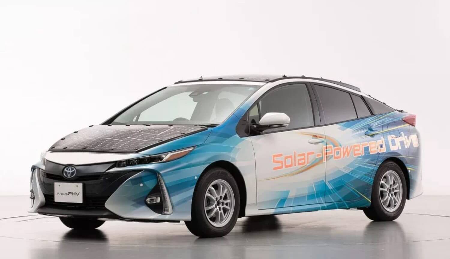 Voiture Toyota est recouvert de panneaux solaires et de la charge sur la route